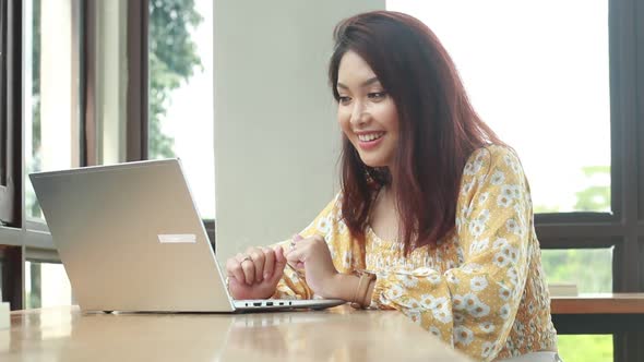 Young asian women in online meeting with laptop in desk