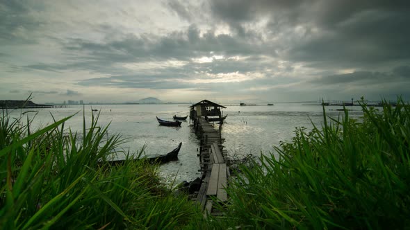 Timelapse fisherman wooden hut with foreground of grass