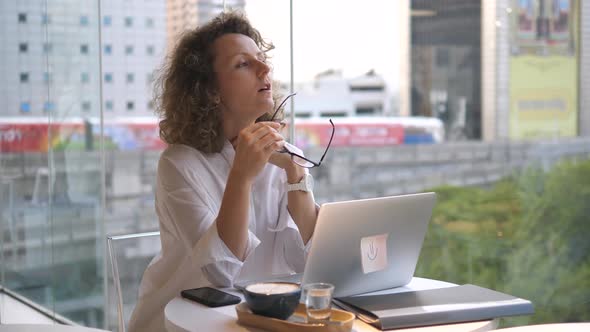 Young Business Woman Using Laptop At Coworking Cafe