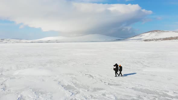 Aerial View Caucasian Woman With Boy Walks On Paravani Lake