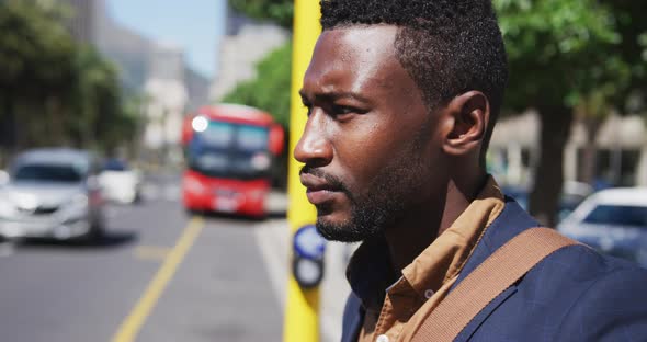 African american businessman looking around in busy city street