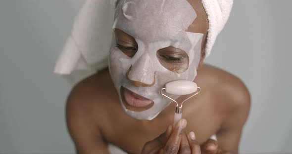 Black Girl Doing Facial Massage with a Roller