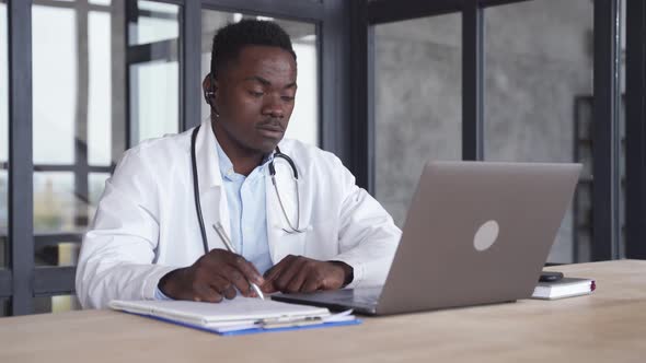 Black Male Doctor Consulting Patient By Telemedicine Online Videocall on Laptop