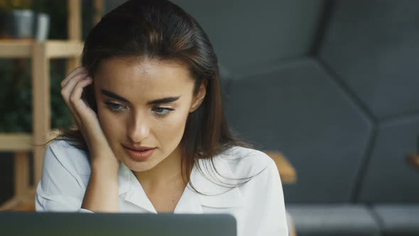 Concentrared Woman Freelancer Working in Modern Cafe