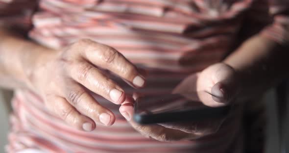 Close Up of Senior Man Hand Using Smart Phone at Home