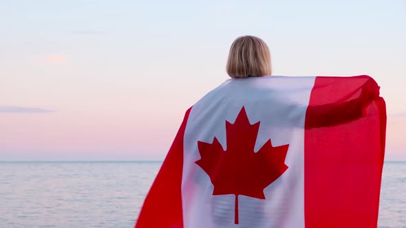 Back View Woman in Summer Clothes with National Canada Flag Outdoors Ocean Sea Sunset Canada Flag