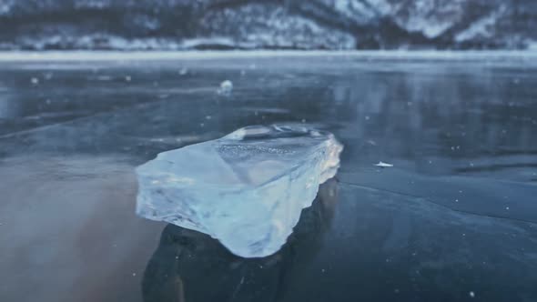 The Ice Floe Rotates on the Ice Against the Background of the Amazing Mountain Landscape. Slow