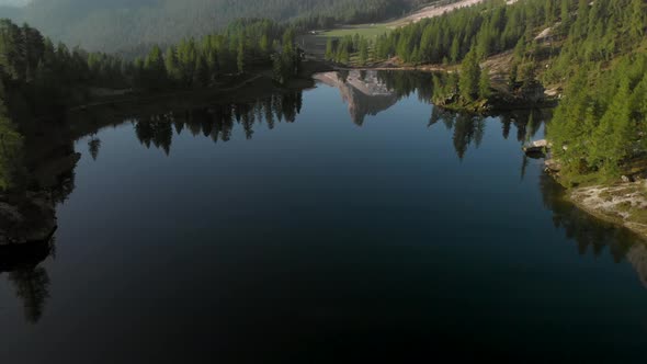 Aerial Flying over Mountain Lake Federa in Dolomites Alps Italy