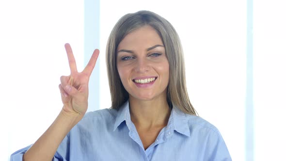 Portrait of Successful Young Woman Gesturing  Victory Sign