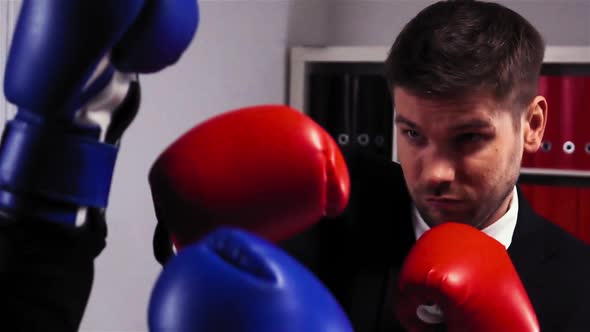 Two Competitors in Gloves Boxing in Office Room