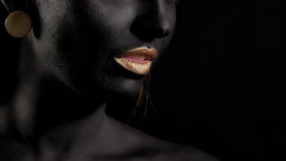 Portrait of a Young Woman with Magical Black Skin and Golden Hands