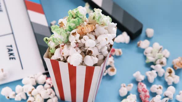 Movie Clapper Board and Popcorn on White Background