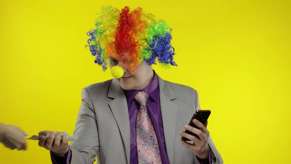 Clown Businessman Entrepreneur Boss Receives Money Income While Using Smartphone