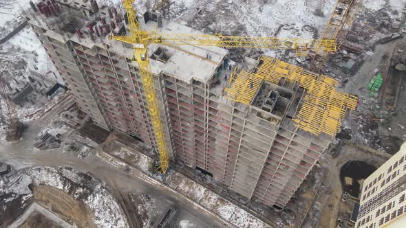 Building under construction site in Winter with snowfall