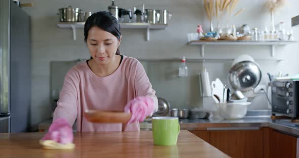 Housewife cleaning the table