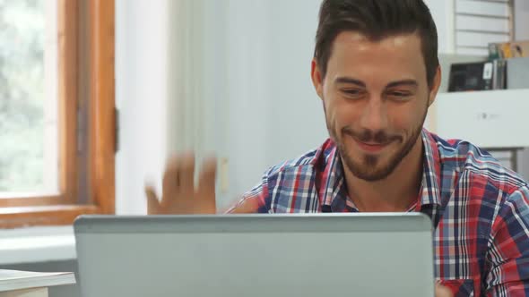 A Young Man Communicates Via Video Communication on a Computer