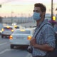 Young Man in Protective Mask with Backpack Waiting for Public Transport at Bus Stop - VideoHive Item for Sale