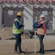 Young Female Contractor Discussing with Male Coworker - VideoHive Item for Sale