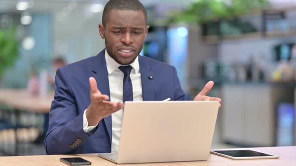 Loss African Businessman Reacting to Failure on Laptop in Office