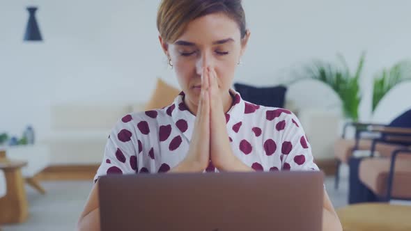 Serious Worried Young Woman Sit with Eyes Closed Put Hands in Prayer with Hope