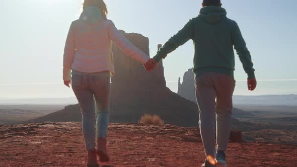 Romantic Couple Walking Together Holding Hands Sunny Morning in Monument Valley