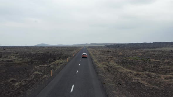 Birds Eye View Road First in Iceland with Panorama Highlands and Driving Car Speeding Up on Asphalt