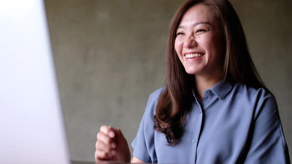 A businesswoman using laptop computer for working online and video conference at home