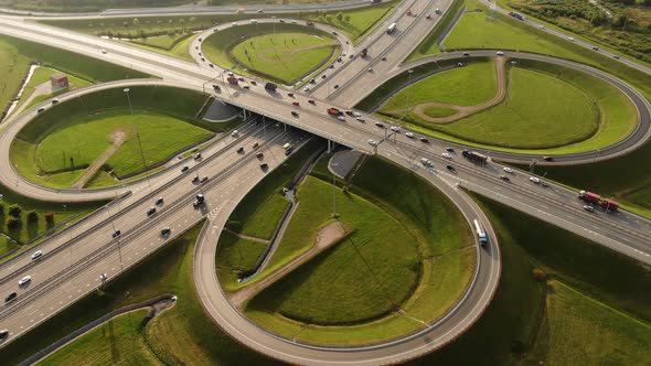 Cars are Driving Along a Large Roundabout Aerial View