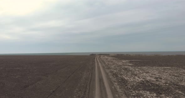 Road Between Vast Plains And Fields