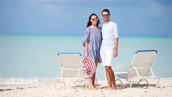 Young Couple on White Beach During Summer Vacation. Happy Family Enjoy Their Honeymoon