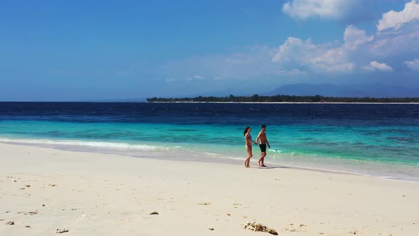 Happy couple on honeymoon vacation spend quality time on beach on paradise white sand background 4K