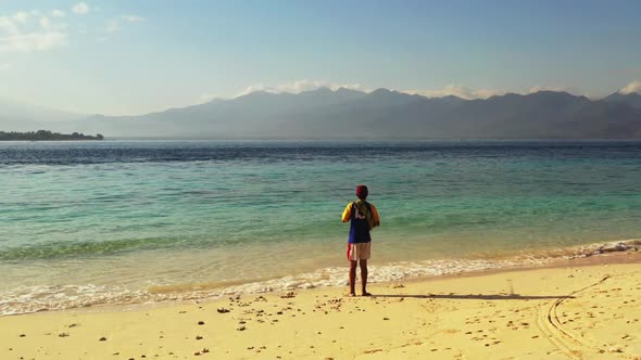 One man angler on perfect coast beach journey by blue ocean and white sandy background of Gili Meno 