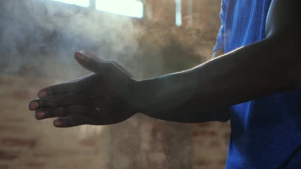 Closeup of male hands applying powder chalk magnesium at gym
