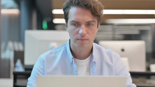 Close Up of Man Working on Laptop