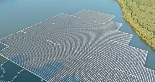 Panels Floating on Water with Floating Solar Panels in a Blue Pond Under the Sunlight