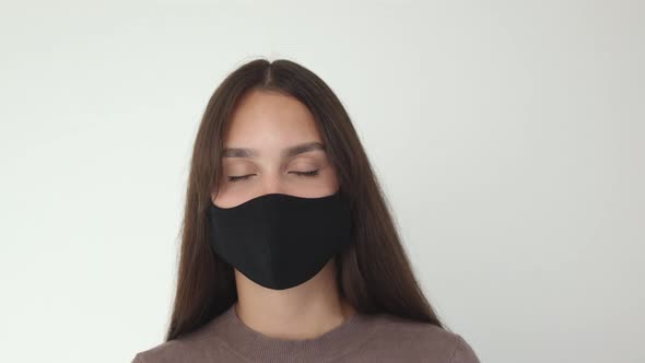 Portrait of Pretty Young Brunette Female in Black Protective Medical Mask Brown