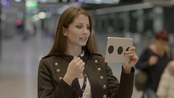 Young Attractive Female Browsing the Internet on Tablet Screen