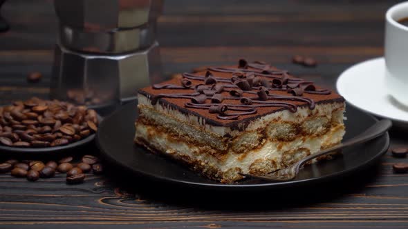 Portion of Traditional Italian Tiramisu Dessert Cup of Espresso Mocha and Coffee Beans