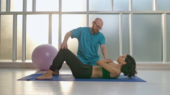 Back Health. The Girl Performs Back Exercises, Which Restore Physical Functions