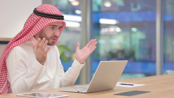 Arab Businessman Reacting To Failure on Laptop in Office, Loss 