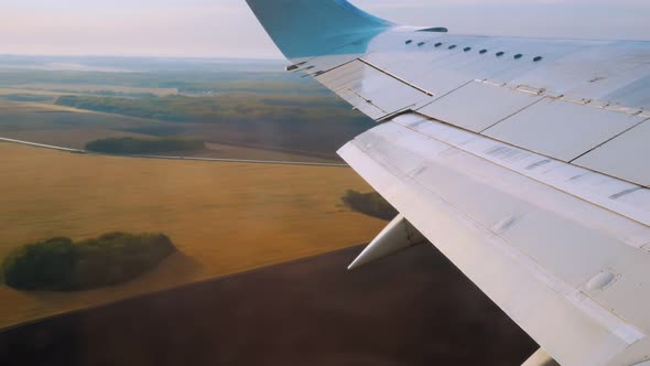 Closeup of a Wing of a Passenger Plane That Takes Off Above the Ground