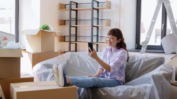 Woman with Phone Having Video Call at New Home