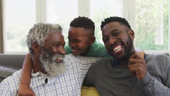 Mixed race man spending time with his father and his son