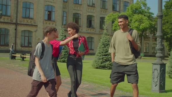 Positive Diverse Multiethnic College Friends Saying Goodbye After Lesson