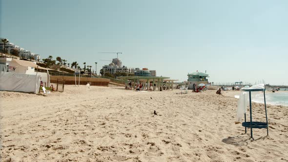 wide view of a modern beach in Israel. People hanging out.