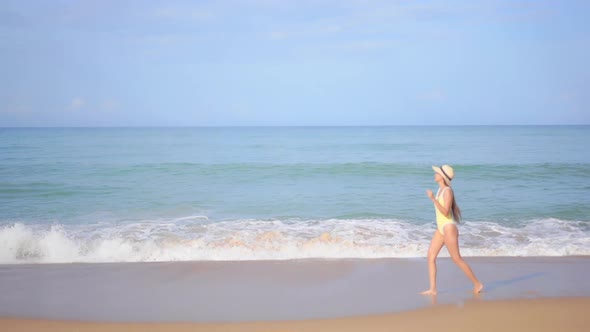 Asian woman enjoy around beautiful beach sea ocean