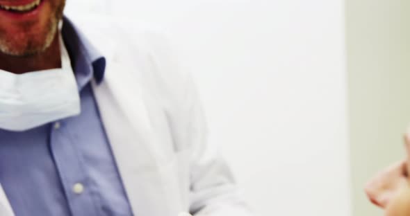 Dentist interacting with female patient