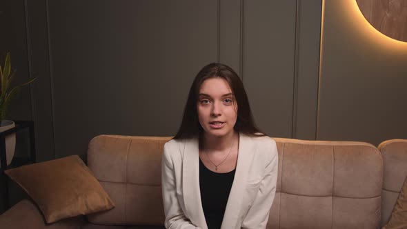 Aggressive Woman Speaking Looking at Camera Talking Make Video Conference on Couch at Home Office