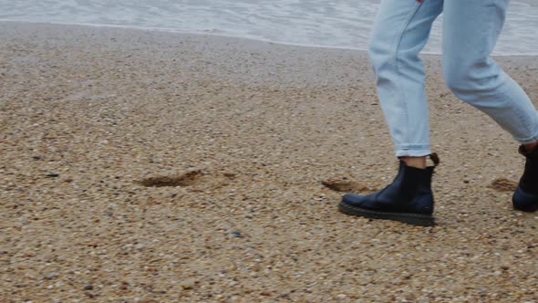 Female Legs Walking On Ocean Coast