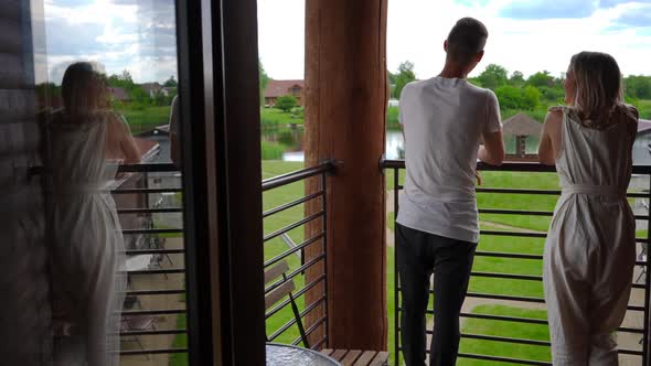 Young Couple Admiring Beauty of Nature at Ecoresort Standing on Terrace and Walking Away Leaving